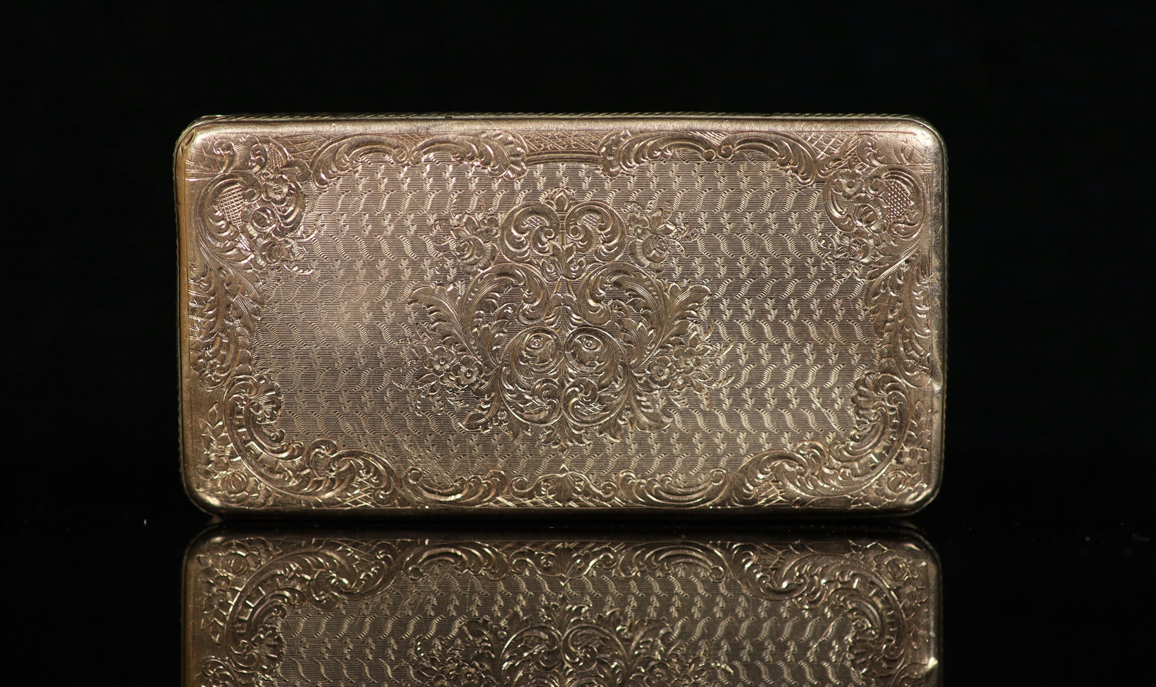 An early 19th century French engraved and engine turned gold rectangular snuff box, with hinged cover